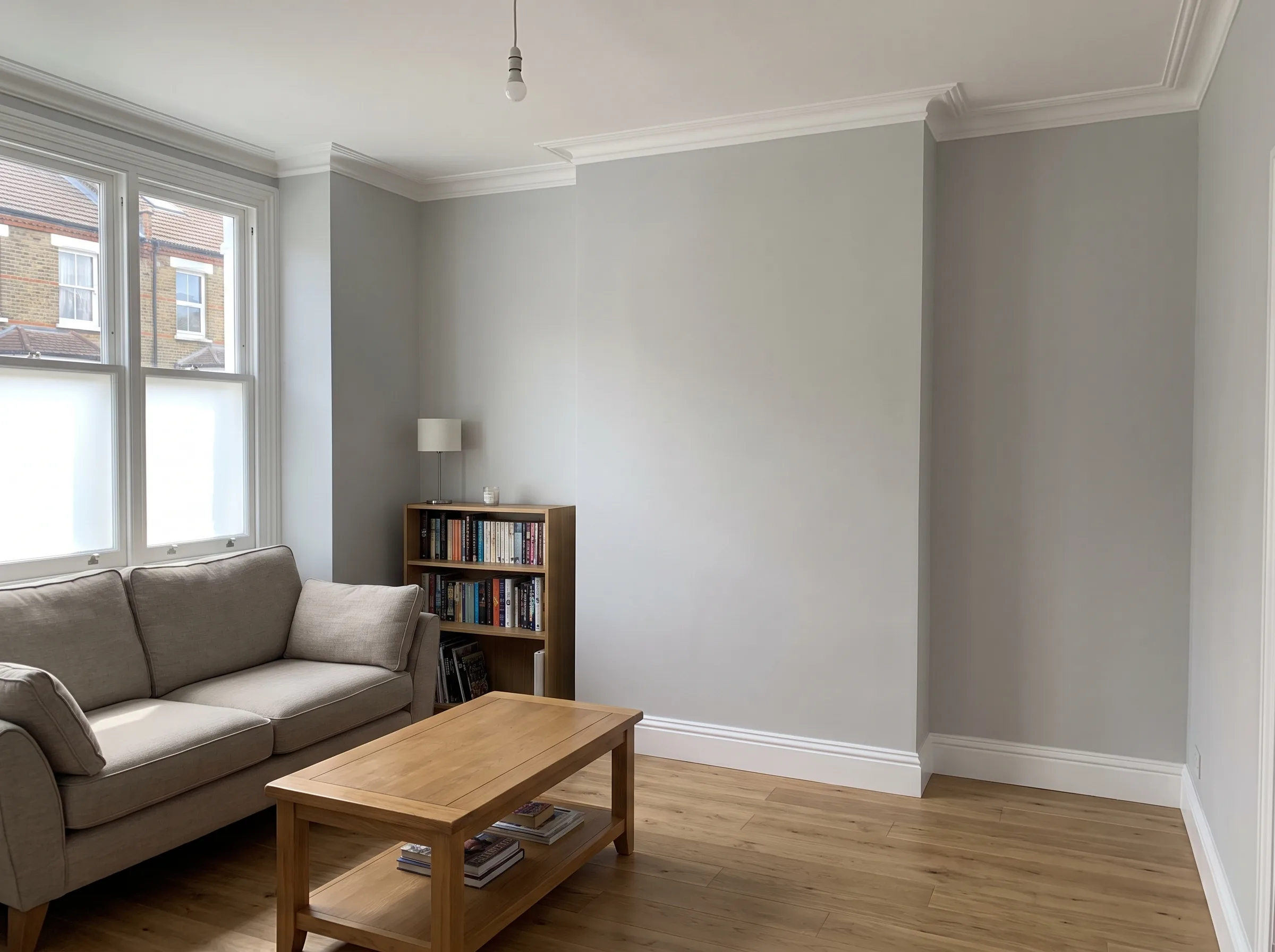 Painter and decorator smoothing a freshly prepared interior wall
