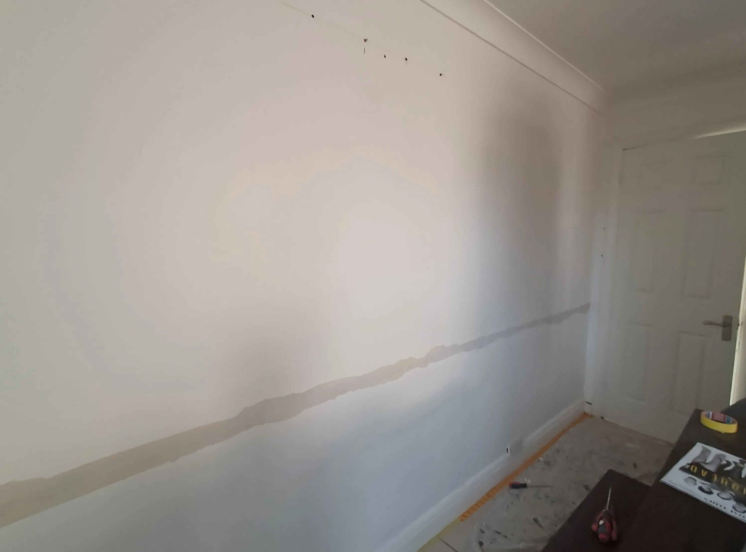 A freshly prepared interior wall ready for painting, showcasing smooth surface preparation