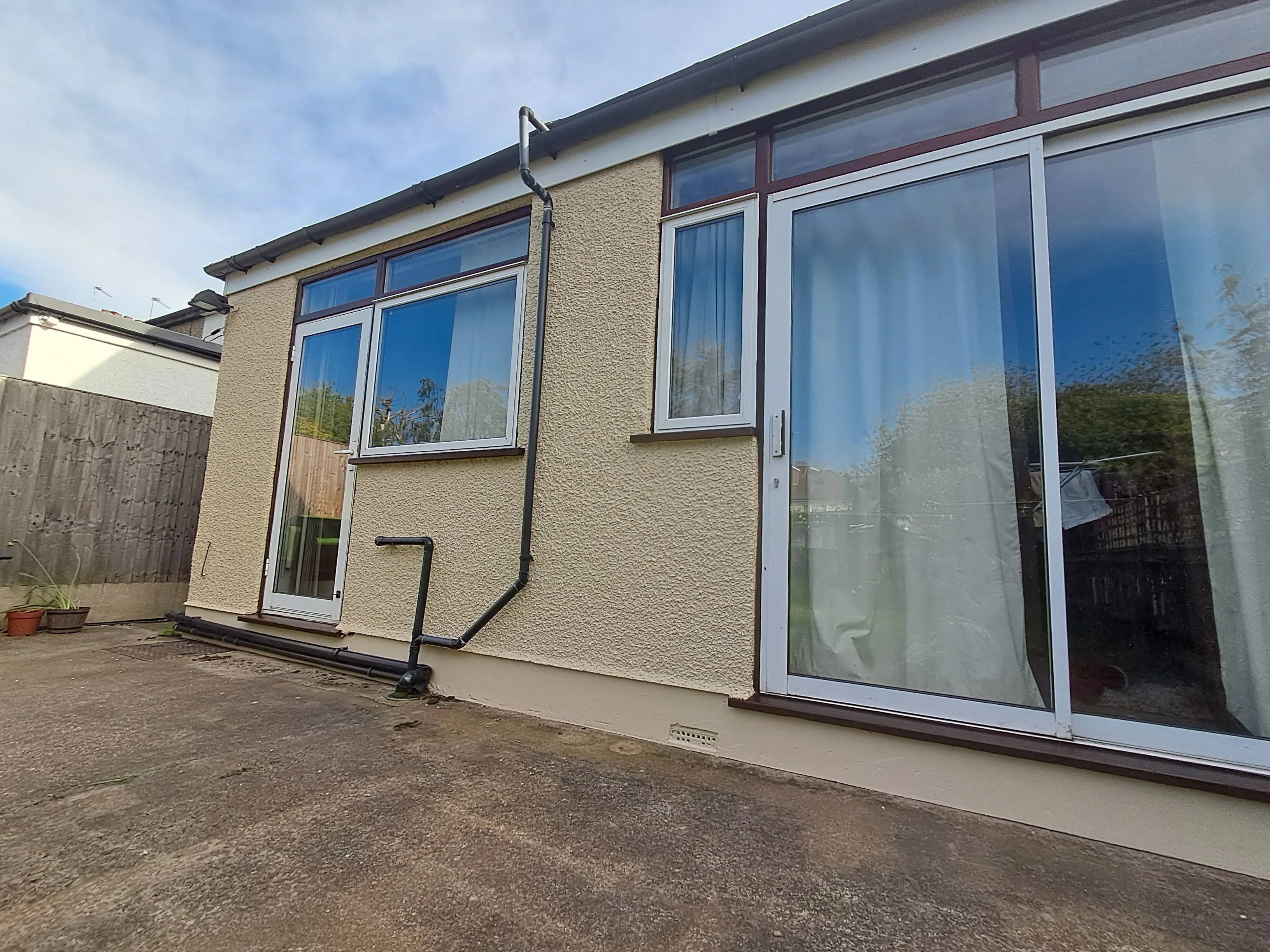 Exterior wall painting of a house with large windows and patio area