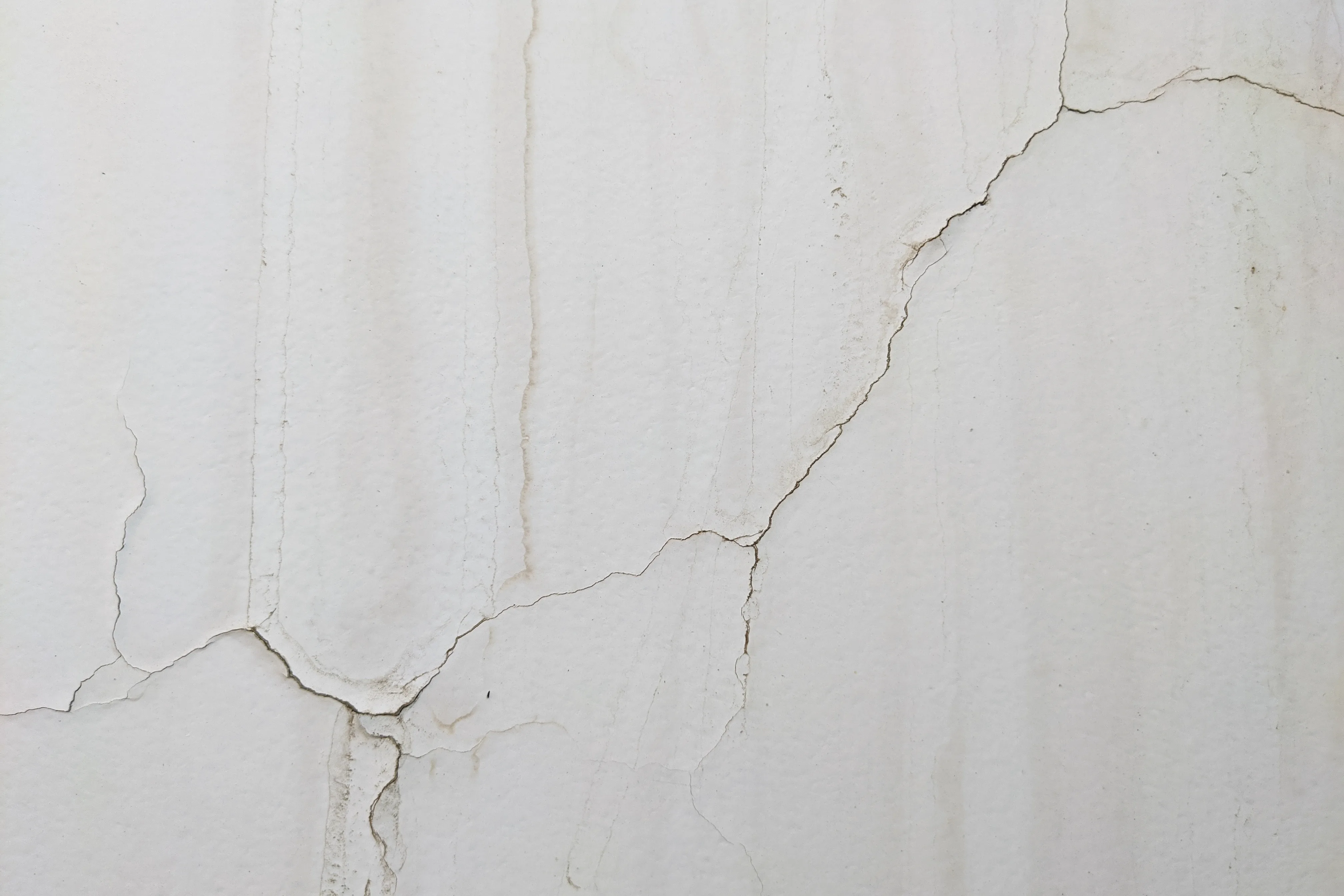 Close-up of a cracked wall surface requiring surface preparation and repair services