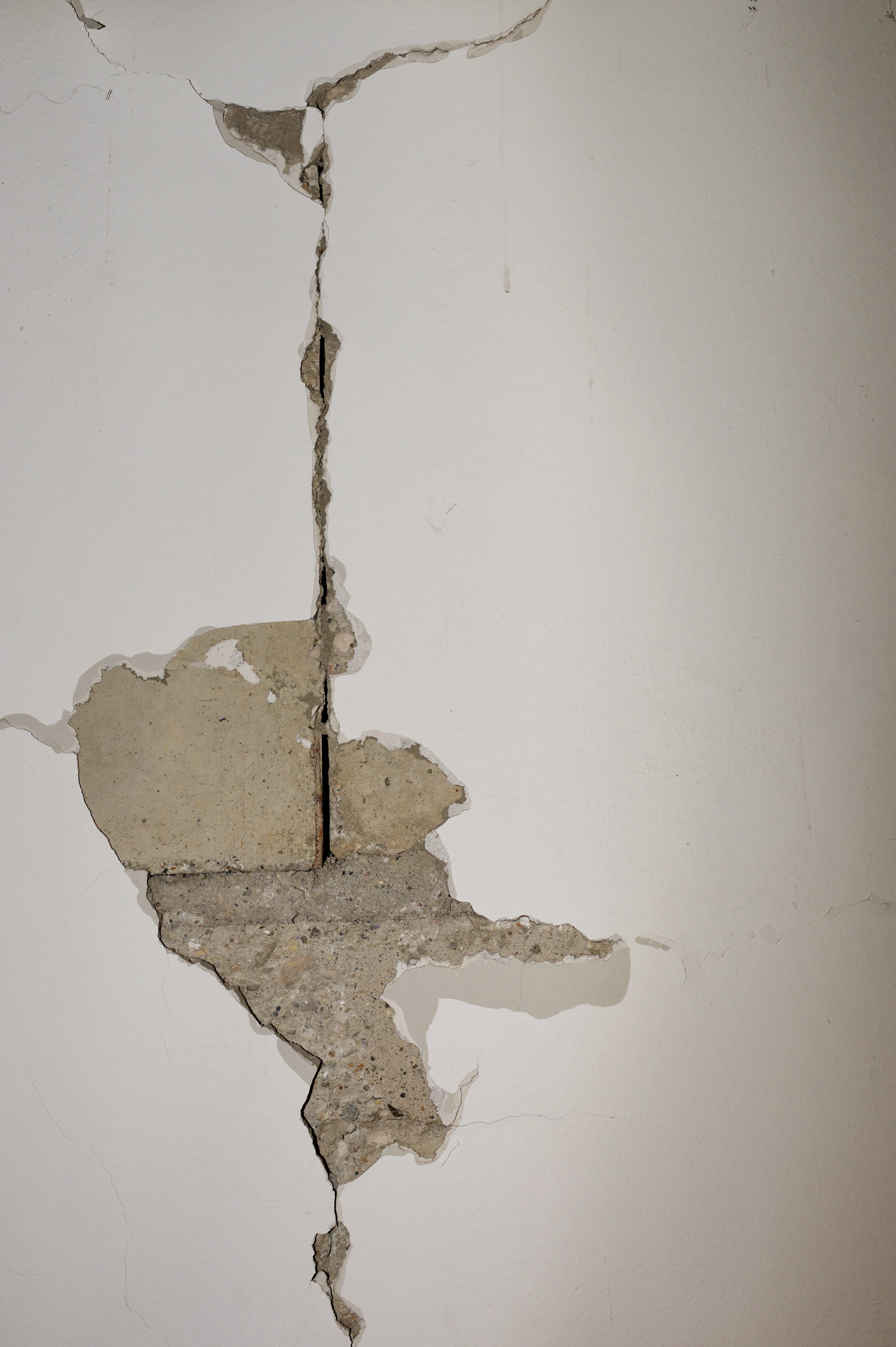 Close-up of a wall showing significant cracks and damage requiring repair services