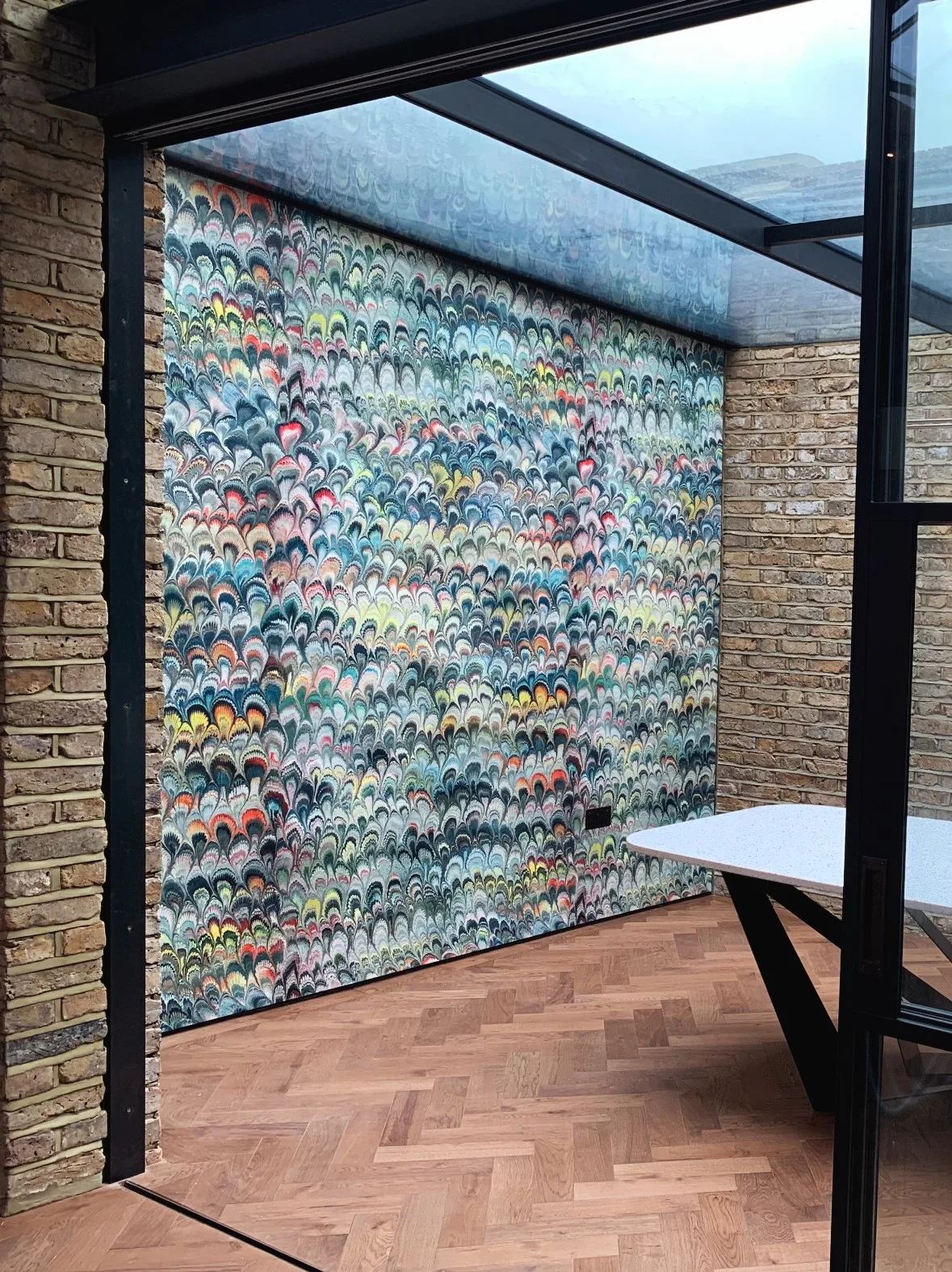 Decorative wallpaper with colorful wave patterns on a feature wall in a modern interior space