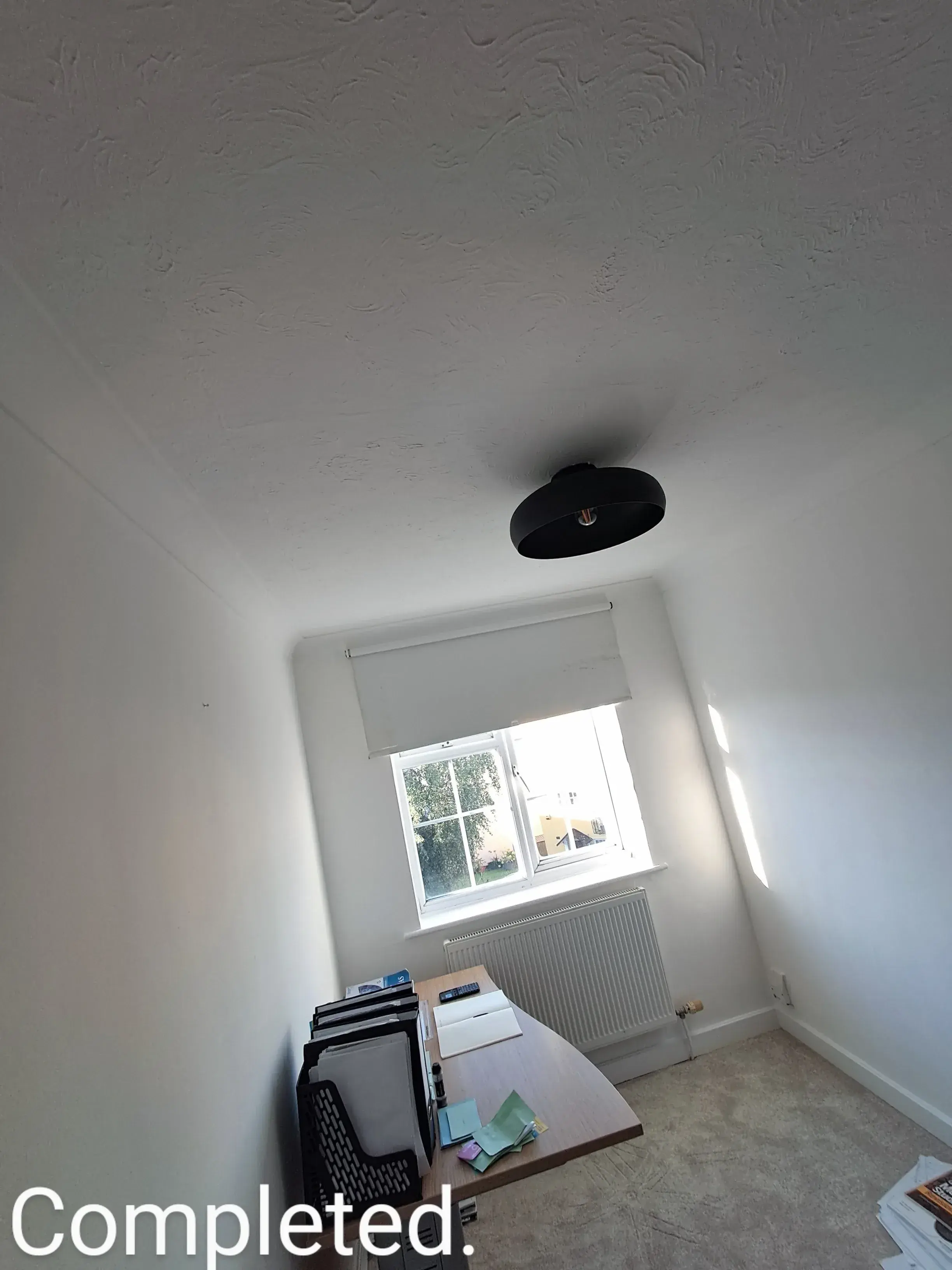Completed interior painting with a clean white ceiling and well-lit space