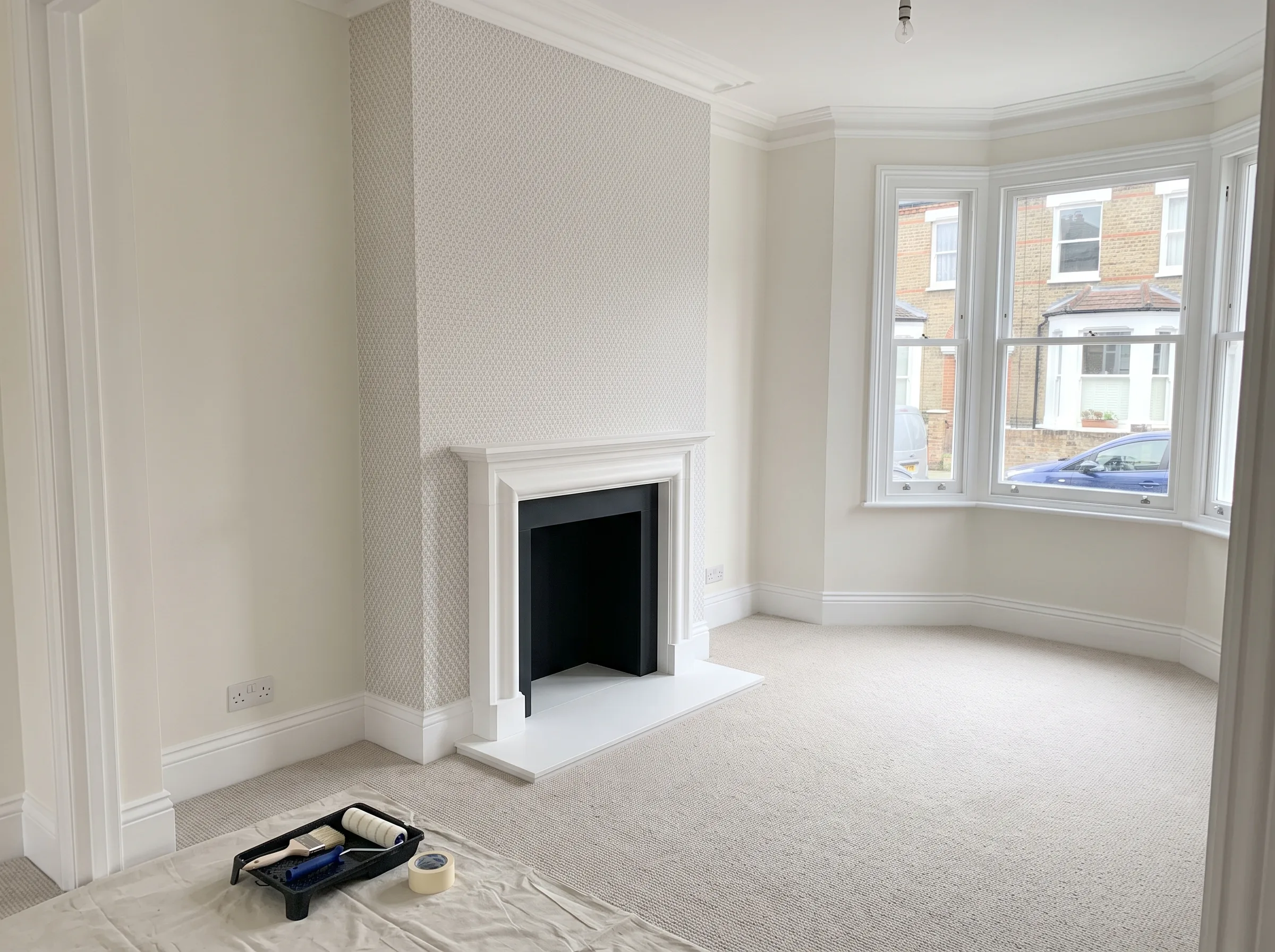 Bright interior with freshly painted walls and a fireplace, showcasing professional Interior Painting services
