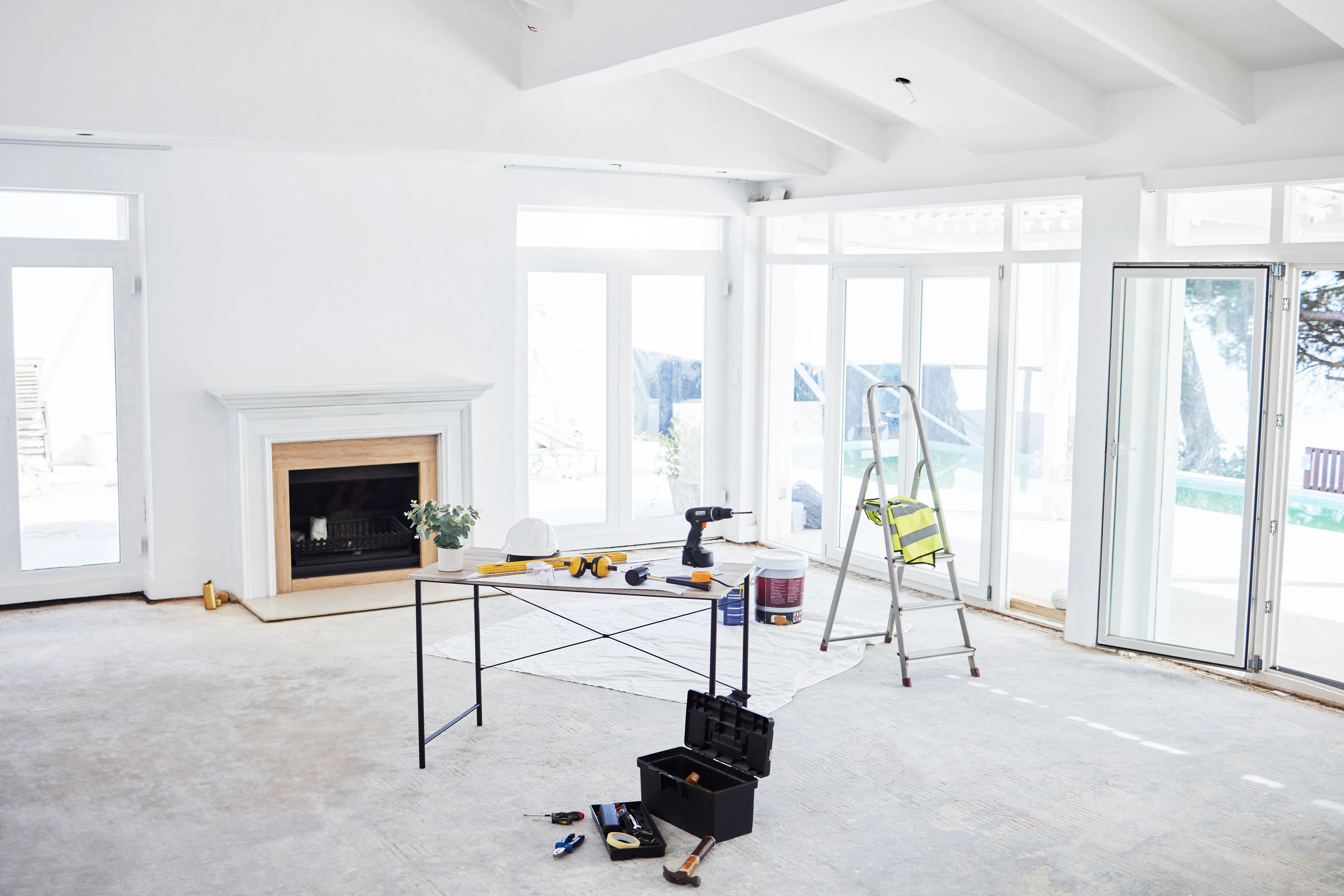 Bright interior of a room under renovation with tools and equipment for painting and decorating
