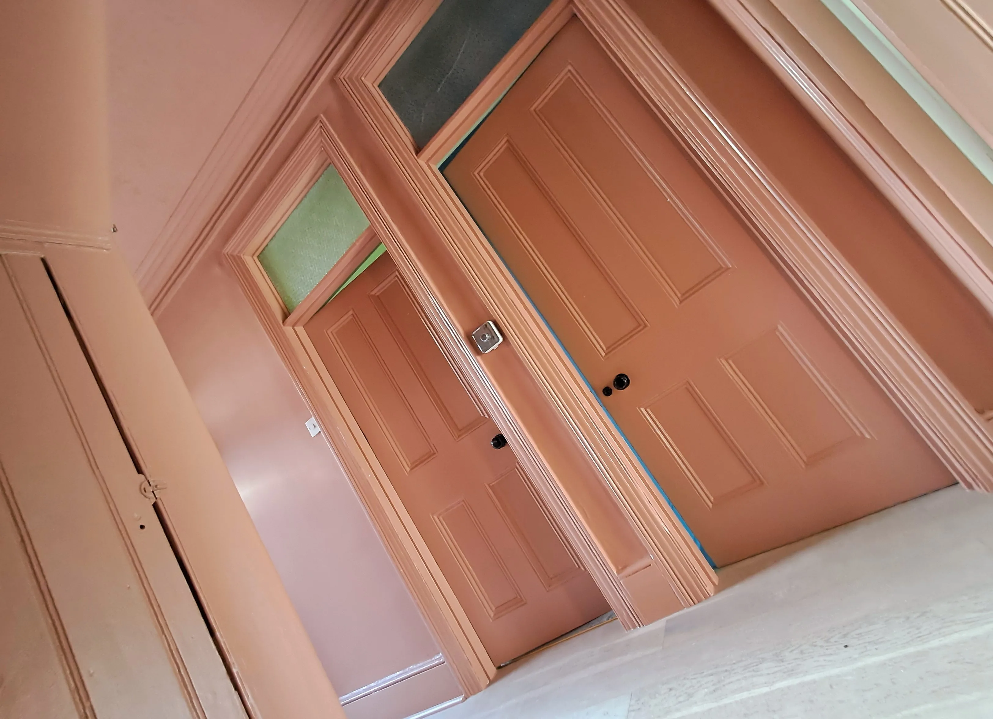 Interior doors freshly painted in a warm peach color with stylish detailing