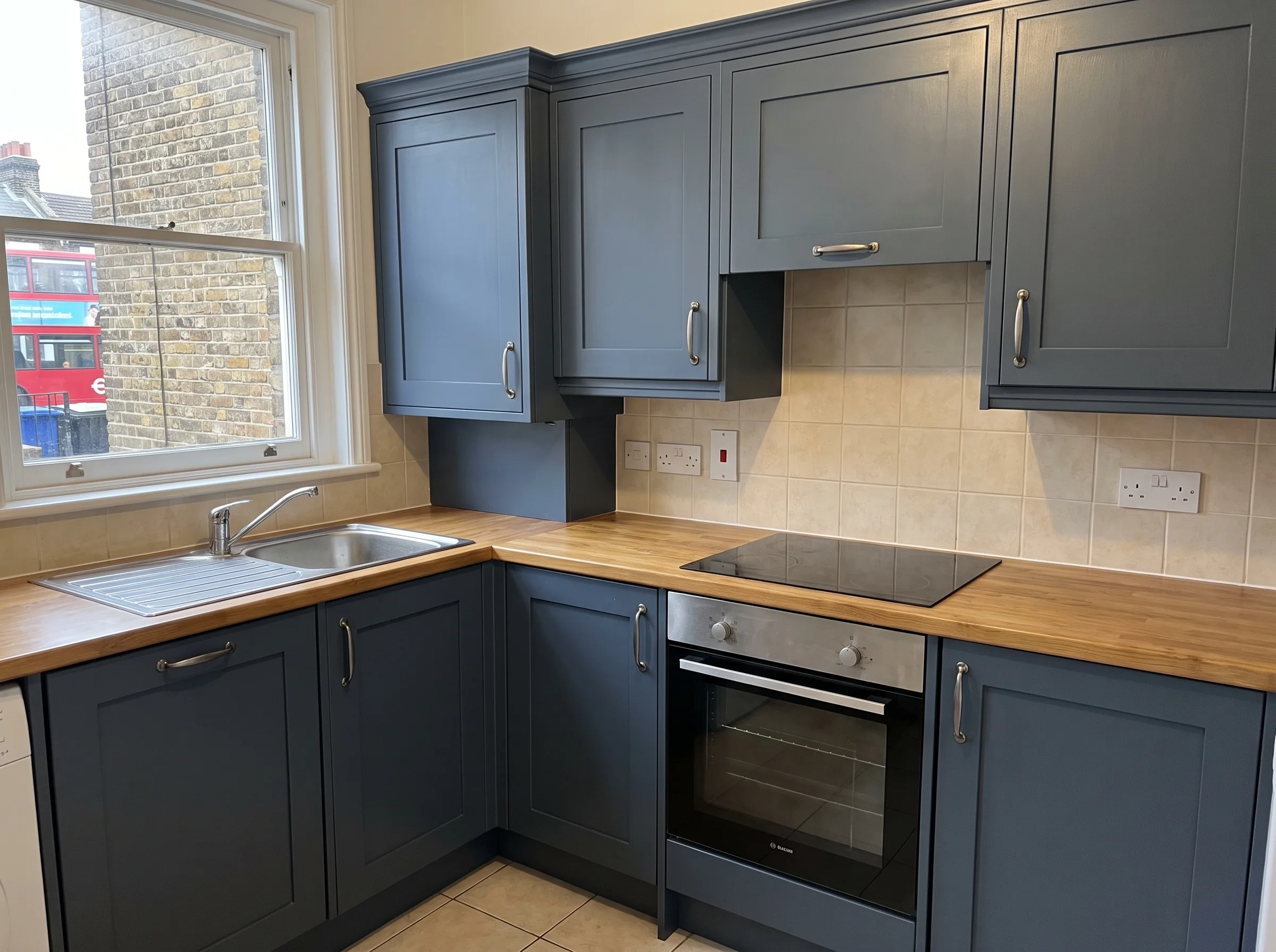 modern kitchen with grey cabinets, wooden countertop, and appliances, showcasing quality workmanship