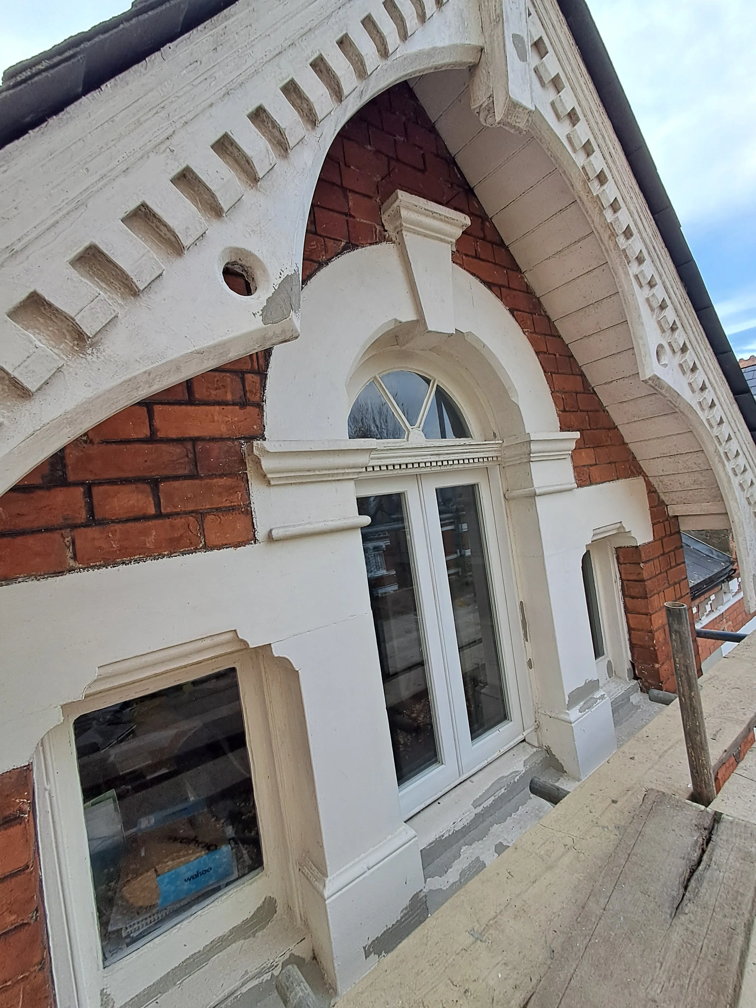 Detailed view of a beautifully painted window frame and facade emphasizing craftsmanship