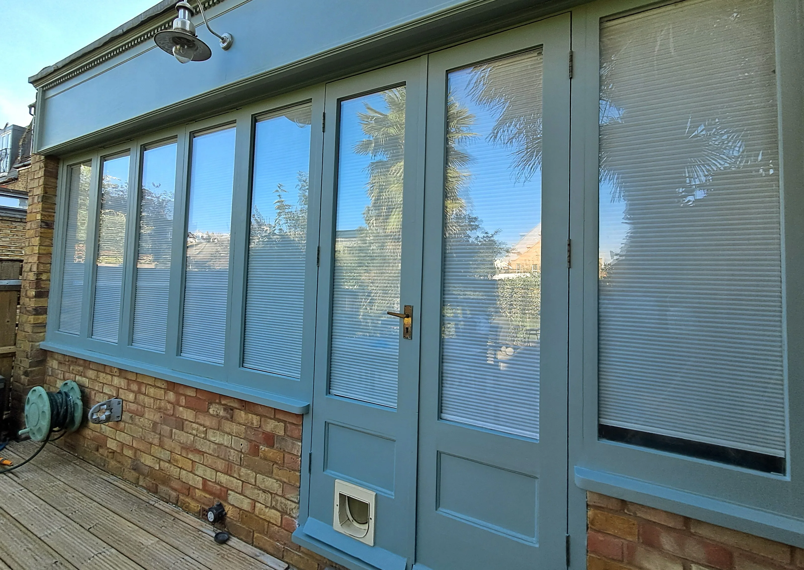 Exterior wall painting of a house featuring large windows and decorative panels