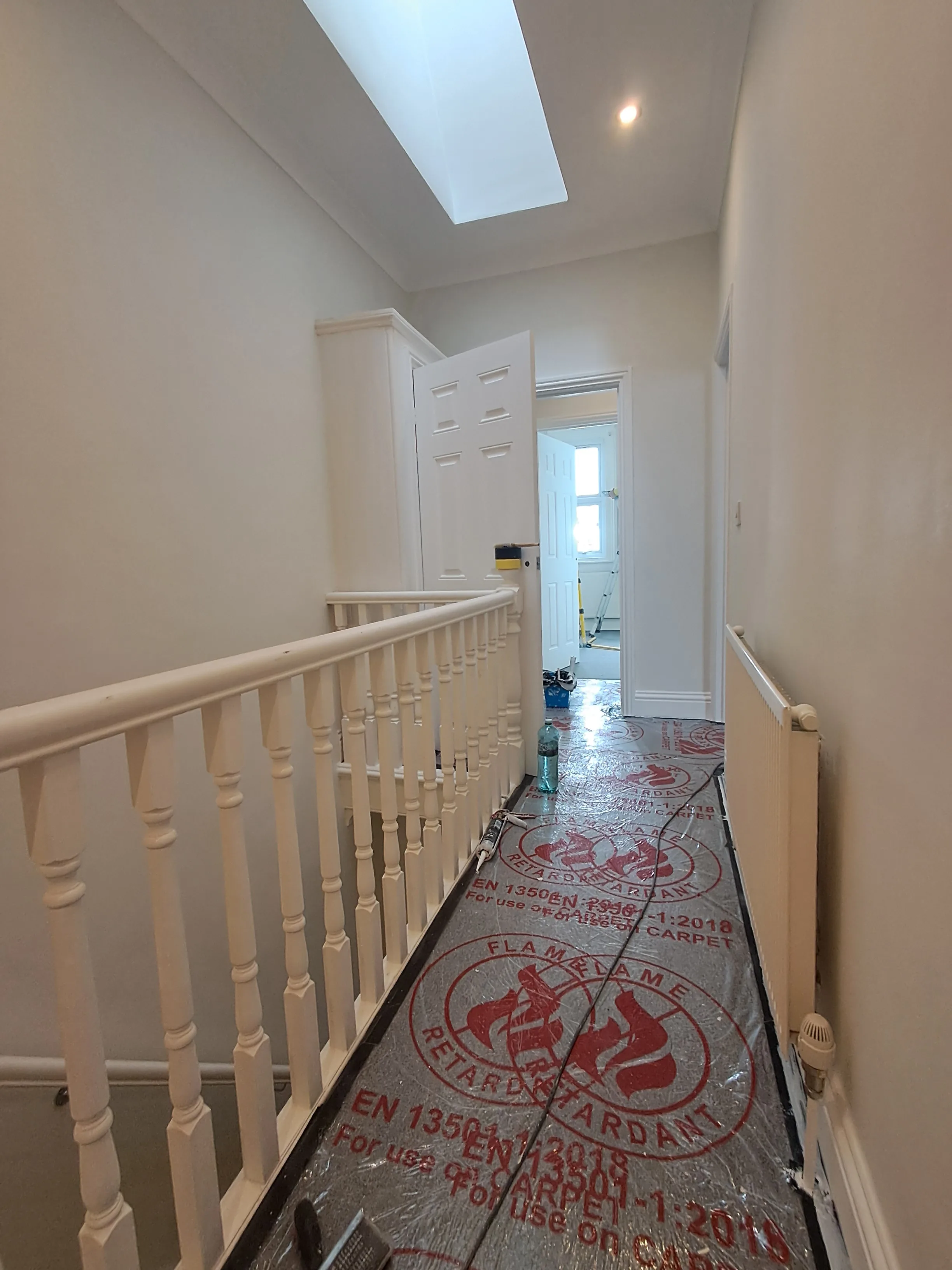 Interior hallway with freshly painted walls and a clean floor, showcasing interior painting services