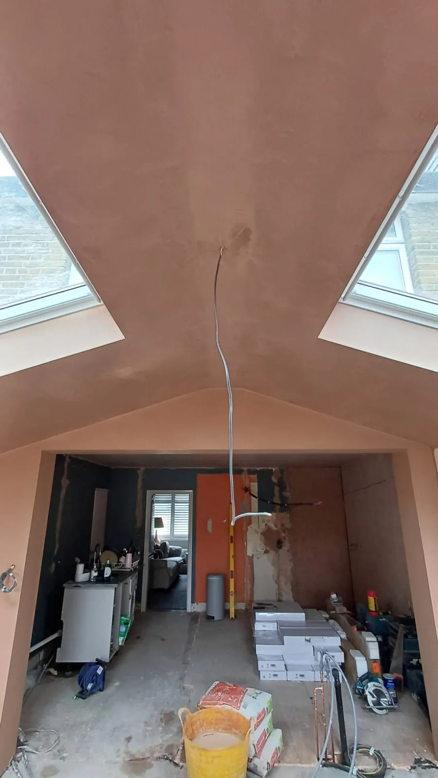 Interior room in renovation, featuring a freshly prepared ceiling and walls ready for painting